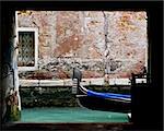 Venetian gondola at the end of an alley.