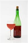 Red wine bottle and glass isolated over white
