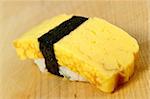 Tamago (Omelet) sushi on a wooden board