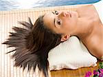 portrait of a beautiful brunette laying down on a wood carpet