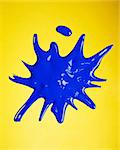 Blue paint splashed over yellow background