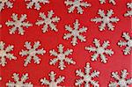 Silver snowflakes on red background