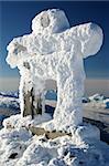 A snow covered Inuksuk, traditional native design and official symbol of the 2010 winter olympics, welcomes visitors to Whistler, BC.