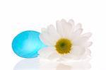 Vivid blue stone and a daisy