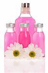 Spa bottles and daisies isolated on white background