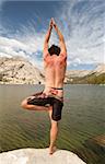 A man in a yoga pose in a beautiful outdoor setting.