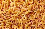 Kids soup letters pasta. Italian food background.