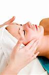A face massage during a facial at a beauty spa with clipping path.