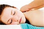 A young female receives a shoulder massage at a spa