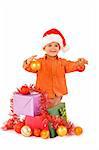 Boy in santa hat with christmas baubles and presents - isolated with a bit of shadow