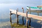 Old small wooden fishing boat in the bay