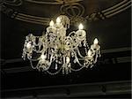 Chandelier hanging from an art deco ceiling