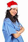 Friendly female doctor in blue scrubs with christmas hat