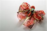 close up photo of red christmas ribbon as decoration