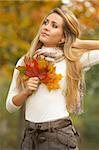 20-25 years old beautiful sexy woman portrait holding leafs in natural autumn outdoors