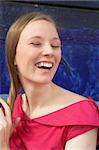 head and shoulders portrait of a laughing girl outdoors