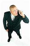 A young businessman with a blue tie and white shirt with cell phone