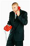 A Young businessman with red classic telephone