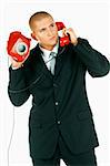 A Young businessman with red classic telephone