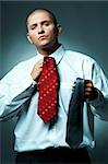 A Young businessman choosing tie