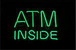 Illuminated ATM Inside neon sign on black