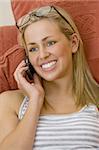 A beautiful young blond woman chatting on her mobile phone