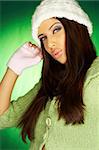 Portrait of beautiful woman wearing green sweater an white hat