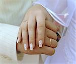 Bride and broom hands with engagement rings put on