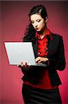 Young Business woman wearing red shirt and black jacket with laptop computer