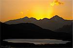 Lake and mountain silhouette on sunset