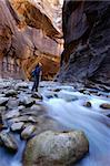 Woman hiking a slot canyon in the Narrows, Zion National Park