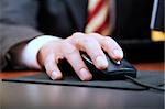 people at work: close-up of a businessman's hand using a mouse