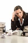 Young woman sitting at her desktop with folders and papers thinking of problems