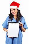 Friendly female doctor in blue scrubs with christmas hat, holding the blank clipboard on white background