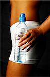 Woman's body part with bottle of water
