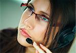 Girl with headset phone at a call center