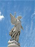 detail of winged angel statue against blue sky