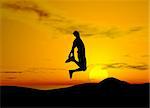 Young boy jumping on air - sunset background