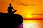 Young boy in meditation position practicing yoga - sunrise / sunset background