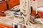 Winch with crank, pulleys and rope on a sailing boat
