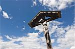 Wooden cross in against cloudscape