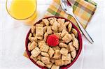 Breakfast Series - A nutritious bowl of shredded wheat squares & strawberries, orange juice and bananas.