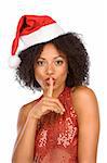 Attractive woman in Christmas outfit with finger on her lips
