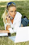 Business woman working on grass with laptop computer