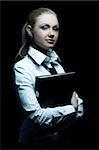 Beautiful business woman wearing black tie and white shirt holding folder isolated on black background