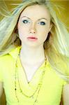 Portrait of beautiful blond woman wearing yellow shirt