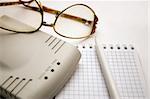 modem, notebook, pen and glasses on a light background