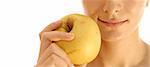 Beautiful young woman eating yellow apple. Isolated over white