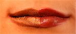 Macro image of bright lips. Red and gold lipstik