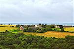 Scenic view on agricultural landscape with a farm house in rural Brittany, France